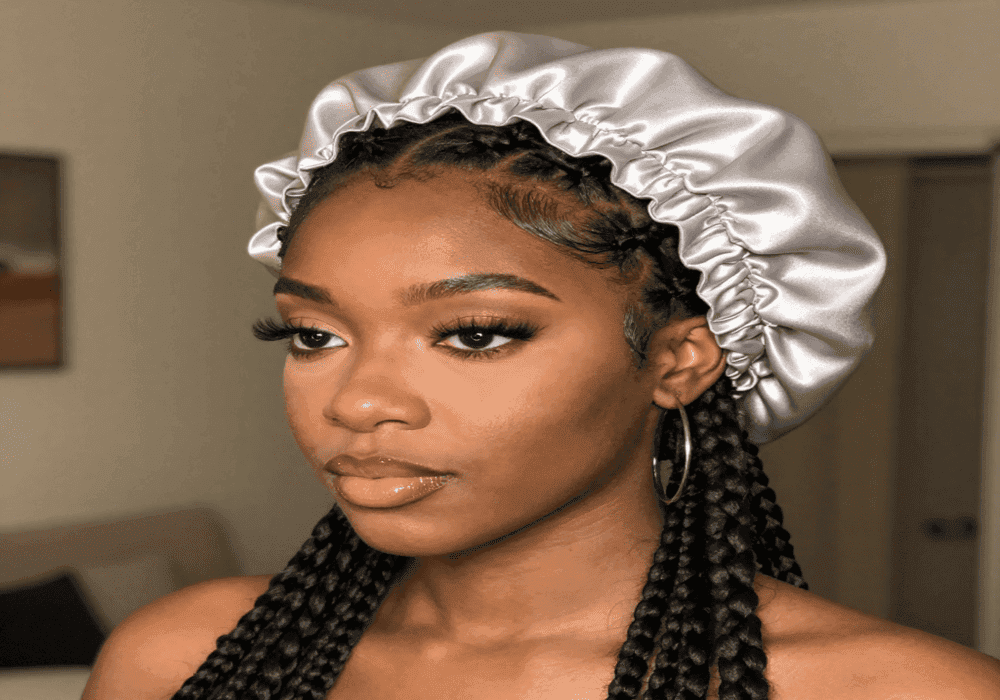 Silk bonnet protecting braided hairstyle overnight to reduce frizz and breakage