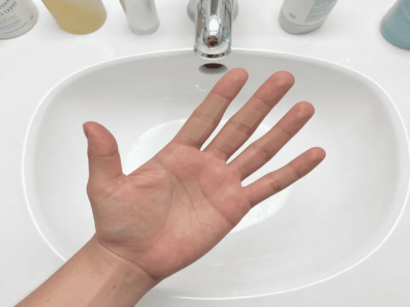 Correct Application Amount for SPF Demonstration of the two-finger rule to ensure proper coverage when applying the best tinted sunscreen for mature skin.